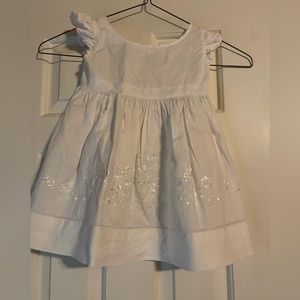 White linen dress with embroidered detail.